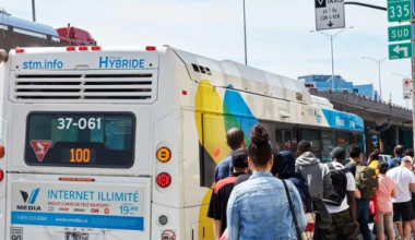 People in queue to enter a street bus in Canada