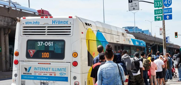 People in queue to enter a street bus in Canada